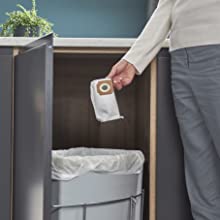 The HyLite dust bag being put into the bin