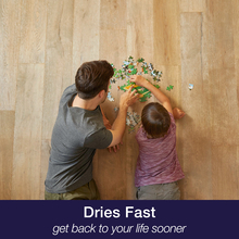 Dad and son do puzzle on wood floor