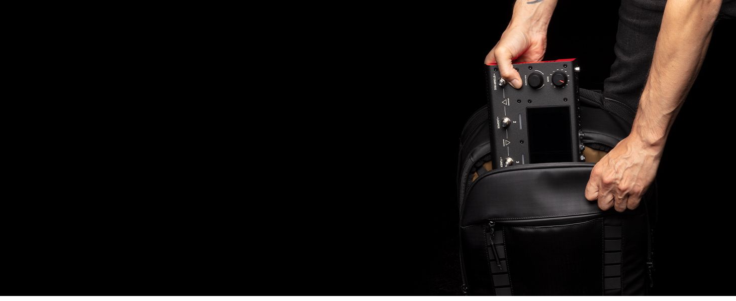 a man putting the Headrush MX5 in a backpack. 