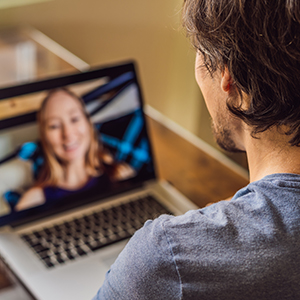 person communicating online via conference app with a friend