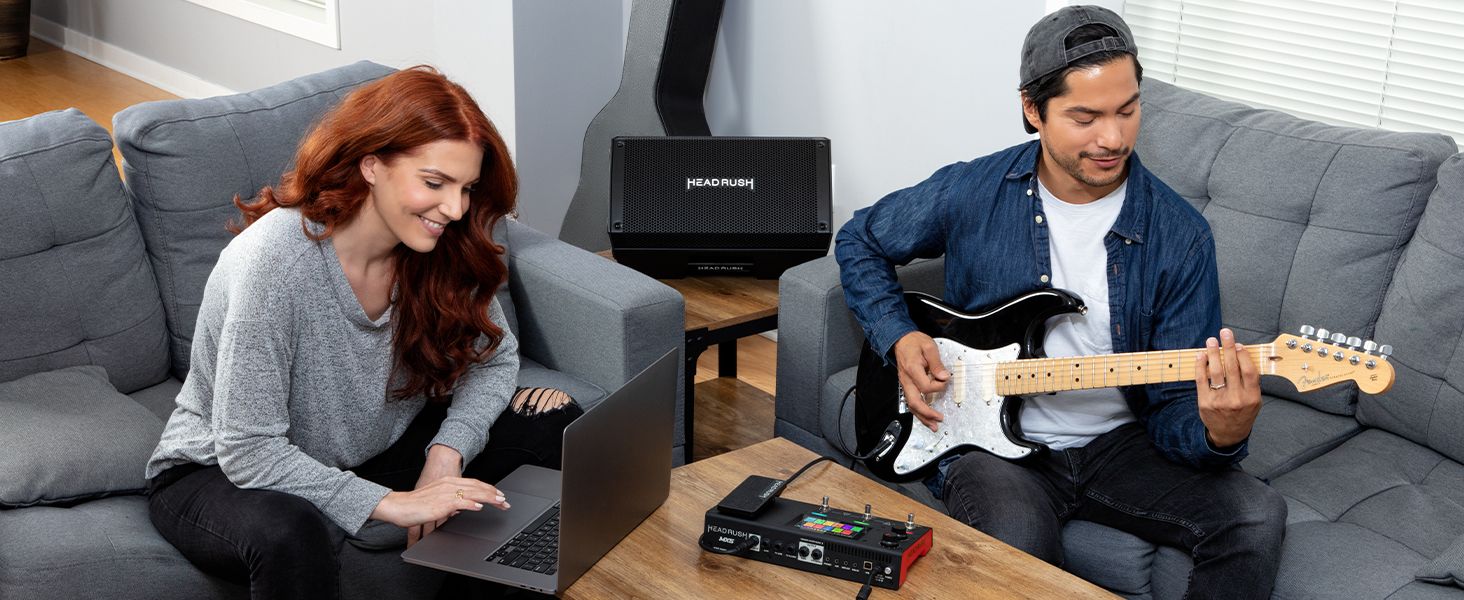 a woman on a PC and a man playing on guitar connected to the MX5 