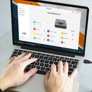 someone on the laptop accessing the creative app that is connected to sound blaster x4