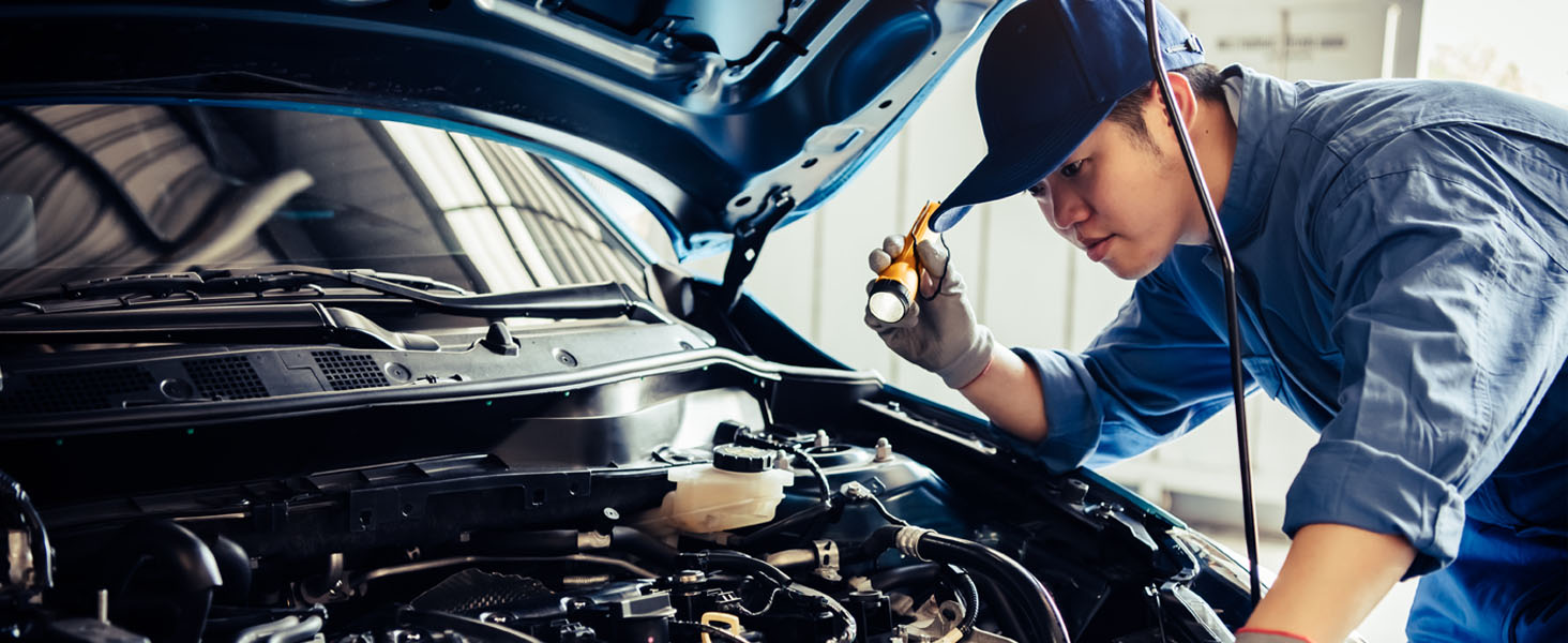 Energizer Torches - Man using work torch to work on car