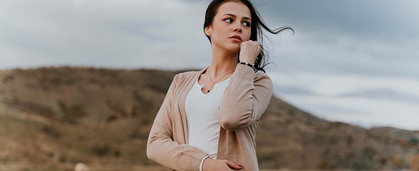 beauty shot, girl wearing aura lava rock bracelet in nature, stress relief, calmness, windy