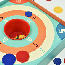 Set includes a scoring zone mat, cup and coloured discs.