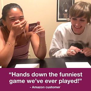 Woman laughing at scrawl of drawing during adult games night