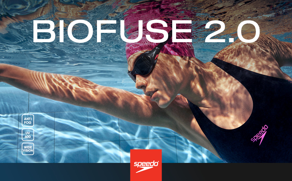 woman wearing black swimsuit, pink cap and black goggles swimming underwater