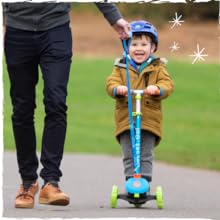 Parent and child together. The parent carrying the scooter with the handy carry strap