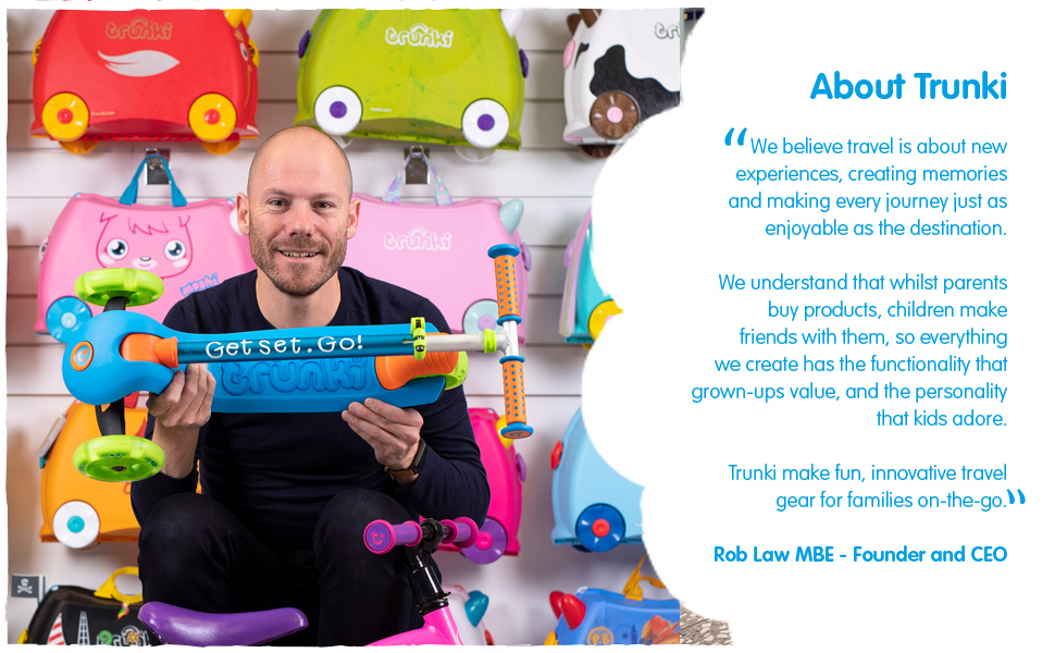 Trunki inventor Rob Law holding the trunki scooter with a description of the trunki brand values