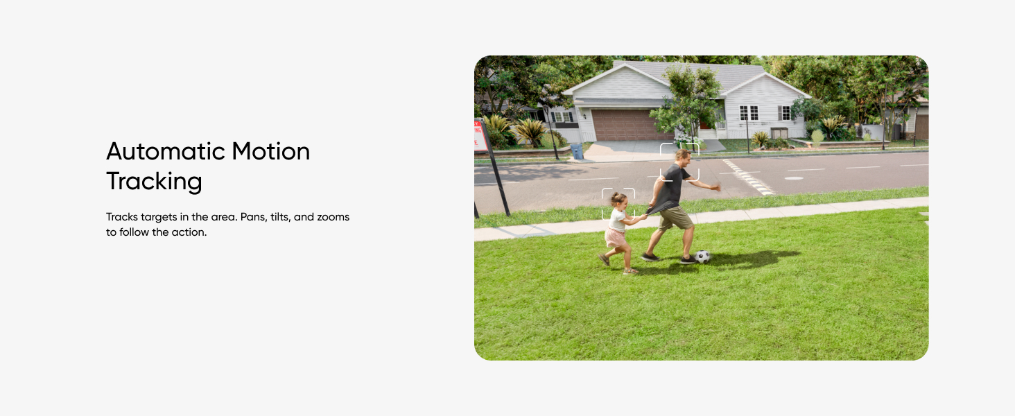 Outdoor scene with a person playing with a dog on a grassy lawn, demonstrating automatic motion tracking feature.
