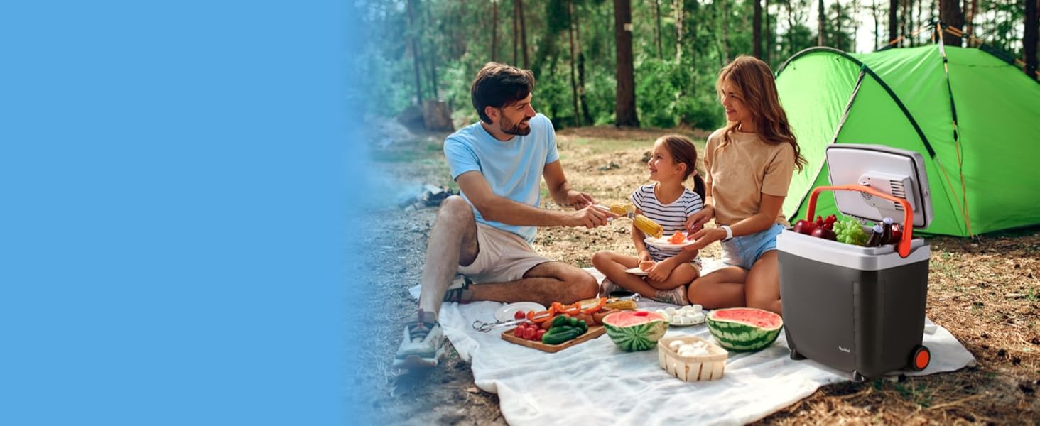 family having picnic with cooler box propped open next to them