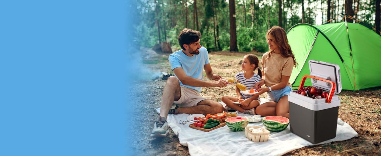 family having picnic with cooler box propped open beside them