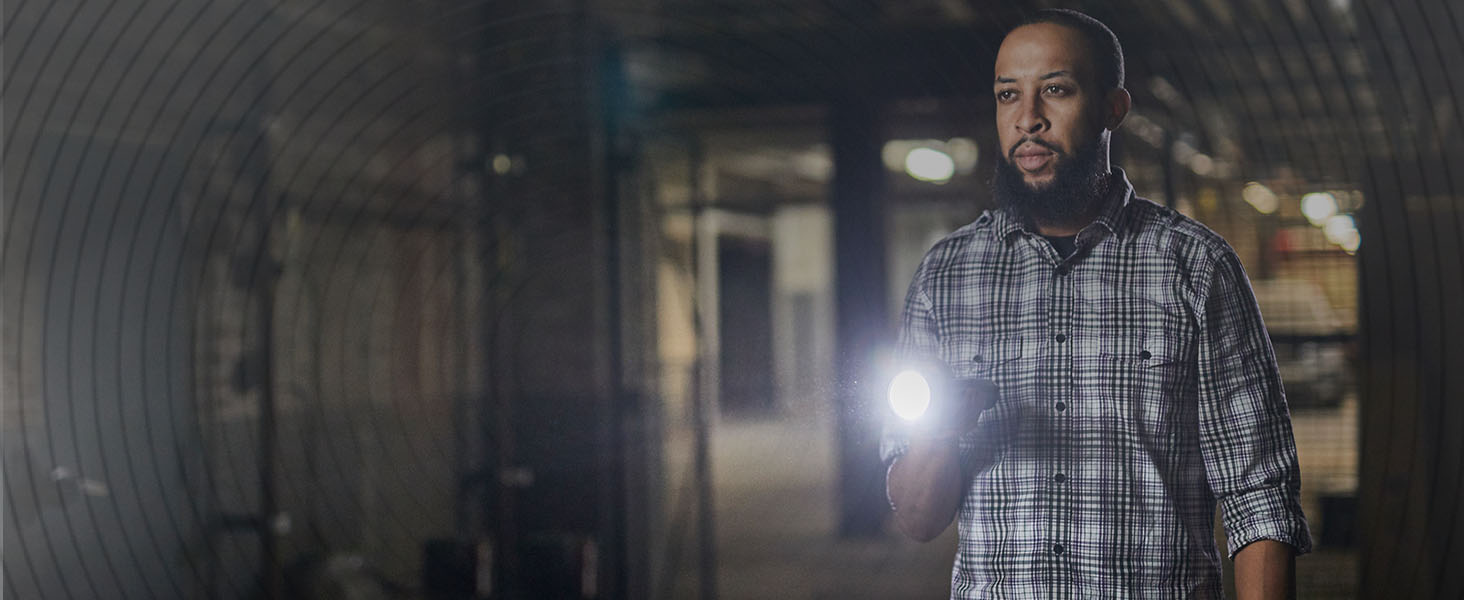 Man standing with a lit Energizer torch in his hand