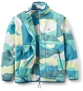 Woman wearing a Passenger fleece in the mountains with a bucket hat smiling and having a good time