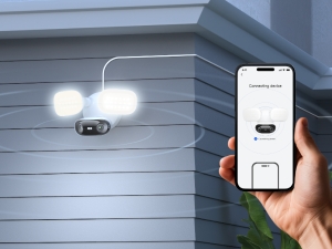 Two white motion-activated security lights mounted on a ceiling corner, with bright LED illumination visible.