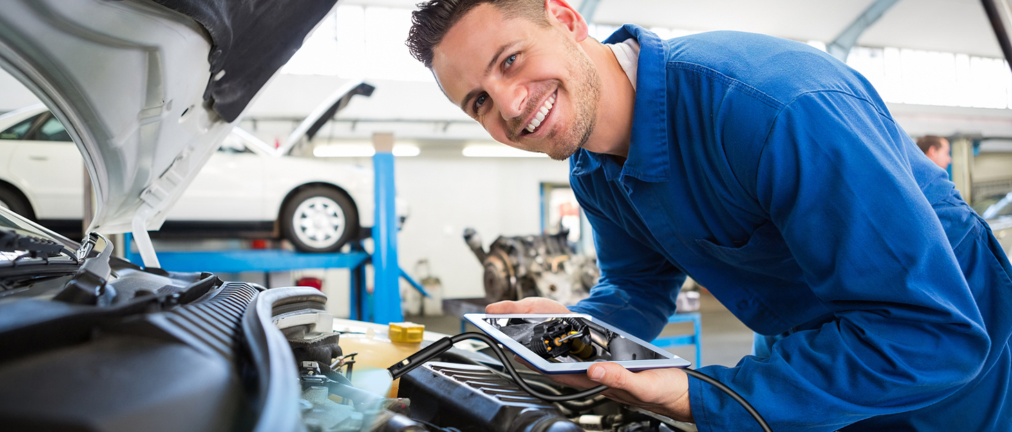 mechanic working on a car engine