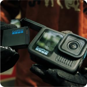 Multiple product shots of a black compact camera or recording device from different angles, showing LCD screen and controls in professional product photography style.