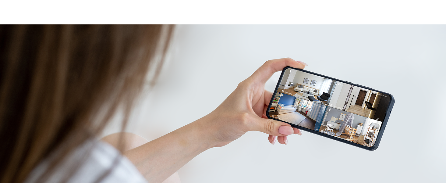 Hand holding a smartphone horizontally, displaying a home interior on the screen.