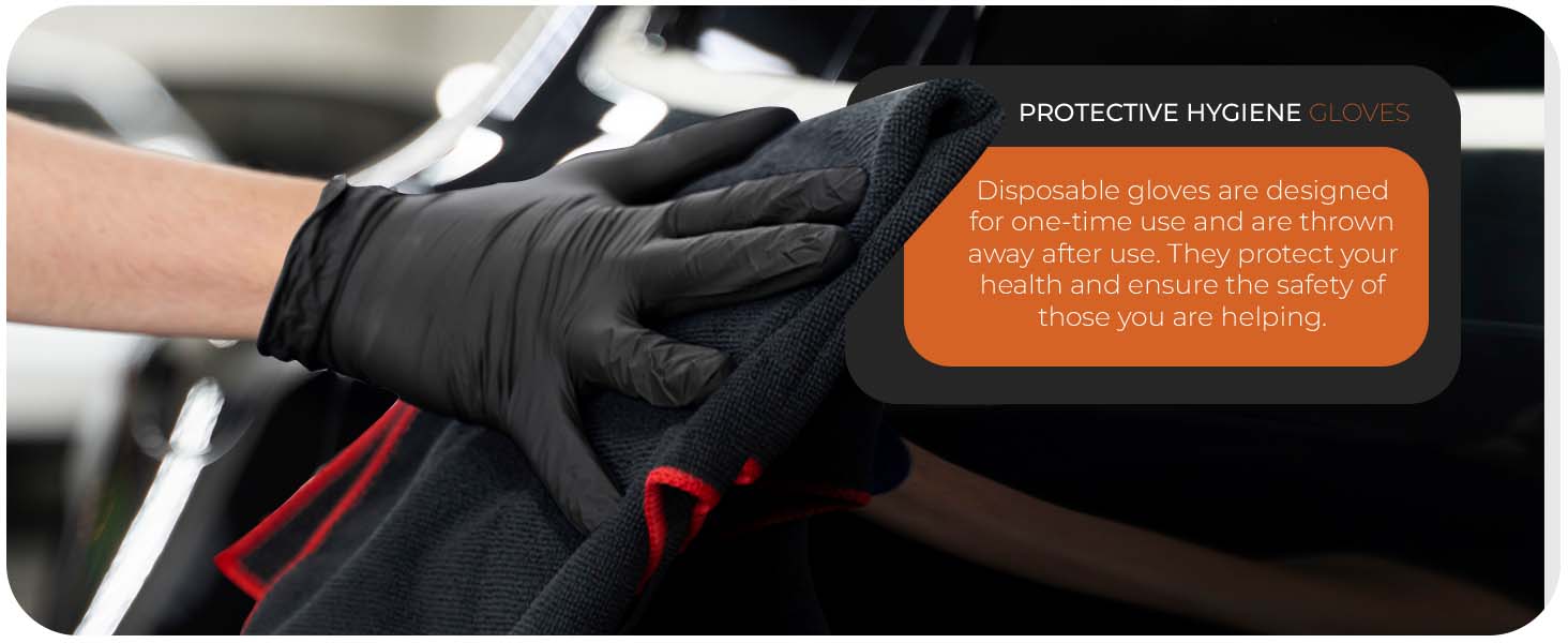 Black protective gloves worn while gripping a handlebar. Orange label visible, indicating protective properties of the gloves.