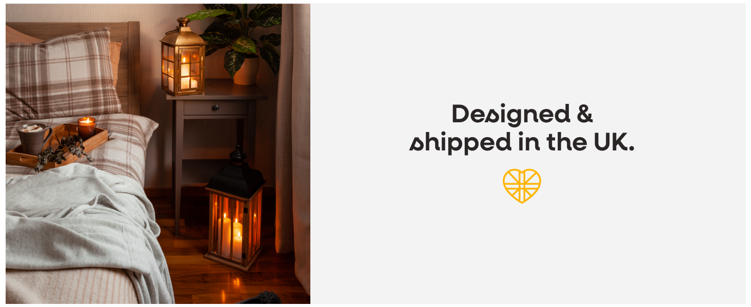 a lamp with a candle on it and a plant in the background.