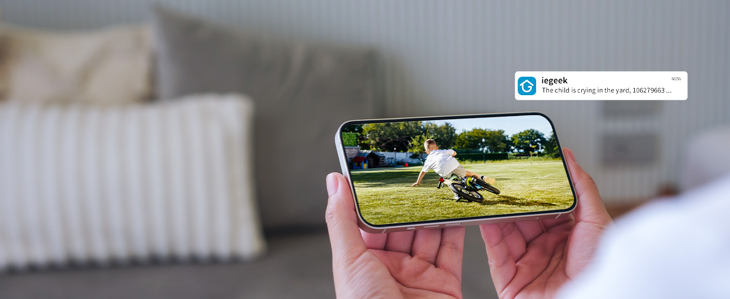 a person holding a smartphone with a picture of a boy playing soccer.