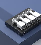 White dome-shaped security camera mounted on a black rectangular device with ventilation holes, likely a network video recorder or similar equipment.