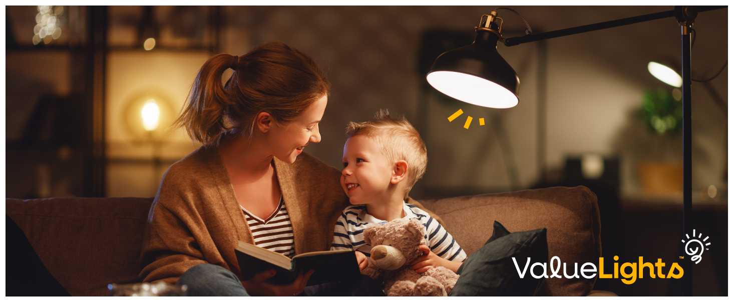 Adjustable desk lamp with black metal shade illuminating a cozy scene. Logo 'ValueLights' visible in bottom right corner.