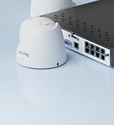 Partial view of a white electronic device with a black circular component visible against a light blue background.