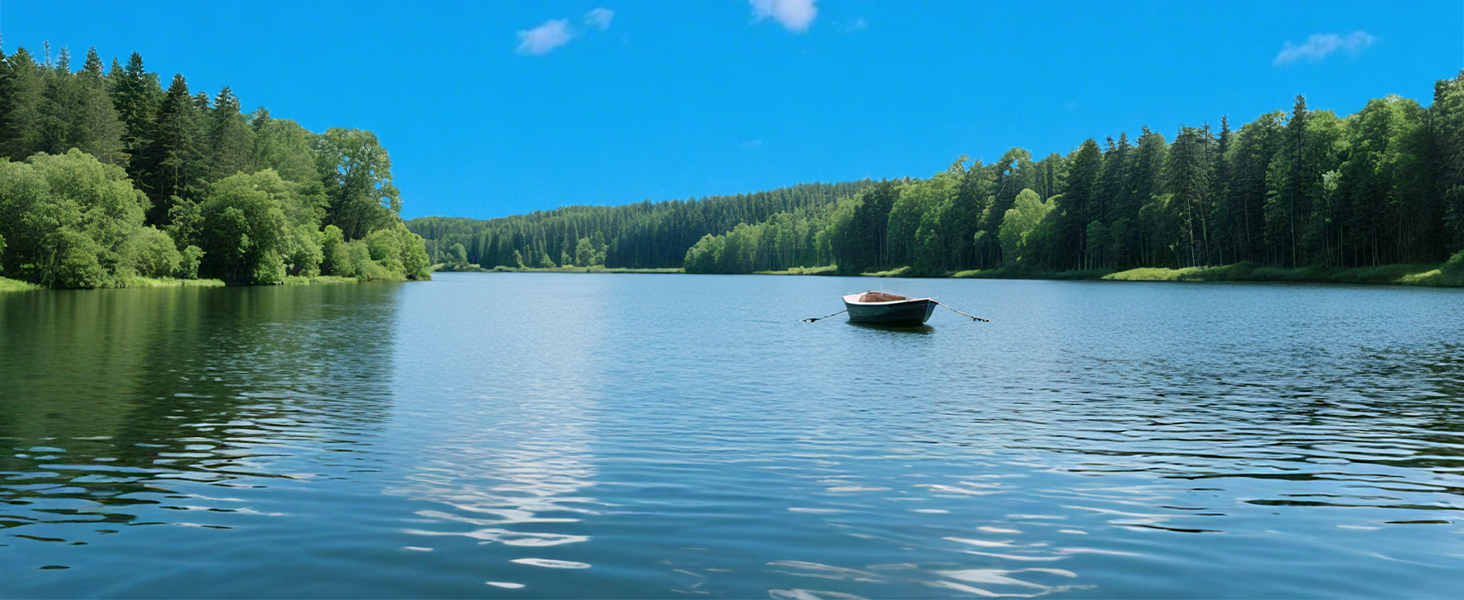 Scenic lake view surrounded by dense forest with calm water reflecting blue sky and a single boat visible in the distance.