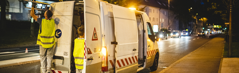 a car driving over a bridge at night.