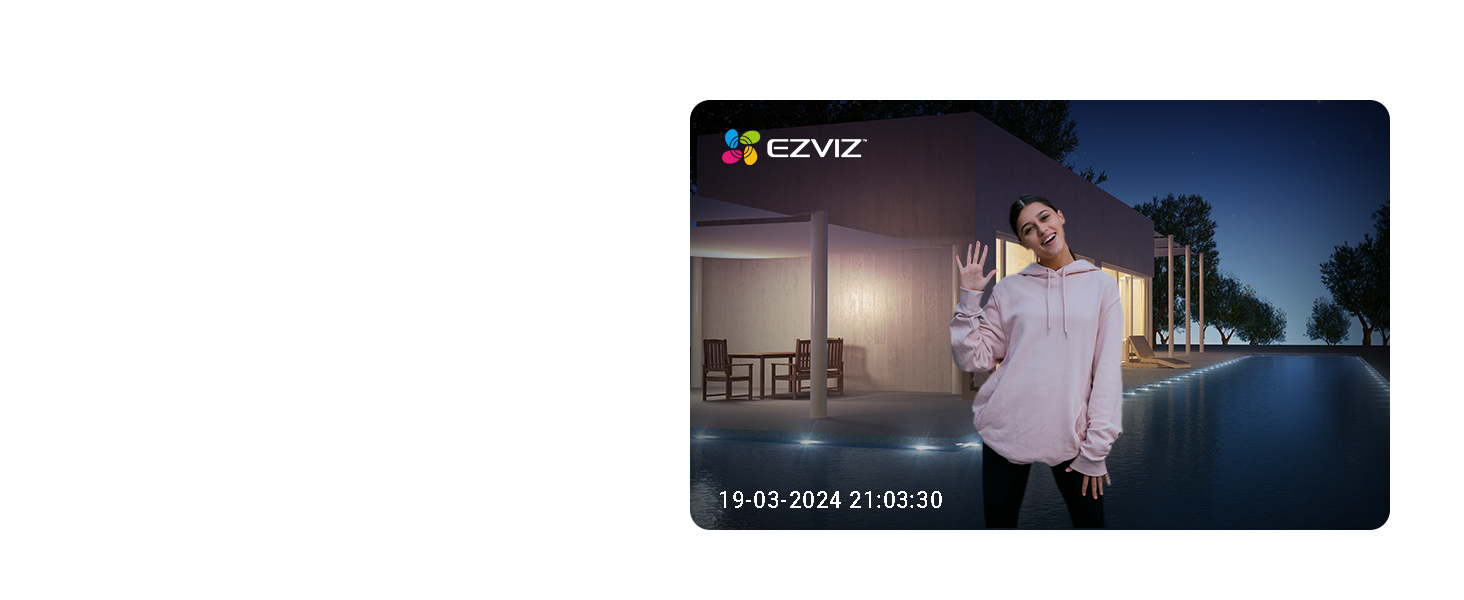 Security camera footage screenshot showing a nighttime street scene with illuminated buildings in the background. EZVIZ interface overlay visible.