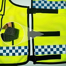 Close-up of a neon yellow backpack strap with black clip attachment. Hand demonstrating the clip mechanism.