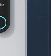 Partial view of a black electronic device with 'ree' visible on its surface. A blue illuminated ring is visible on the device.