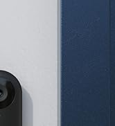 Partial view of a black camera or security device lens visible in the bottom right corner against a gray background.