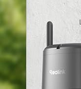 White dome security camera mounted on corner of wooden furniture. Camera has a rotating design for adjustable viewing angles.