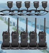 Three black handheld two-way radios shown from different angles, displayed in charging docks with antennas visible.