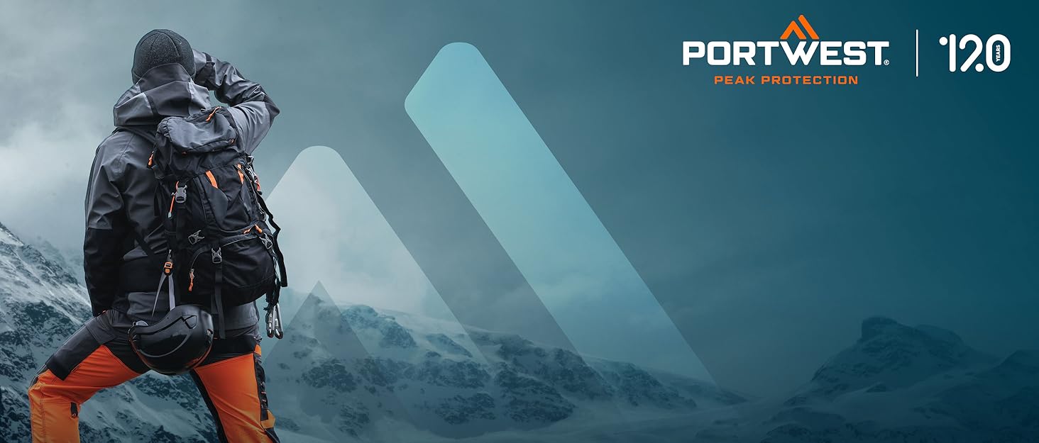 A person in winter gear climbing a snowy mountain. They wear a dark jacket, orange pants, and carry a large backpack. The Portwest logo and number 120 are visible.