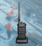 Text reads '50 Floors'. Hand holding a black two-way radio or communication device against urban skyline background.