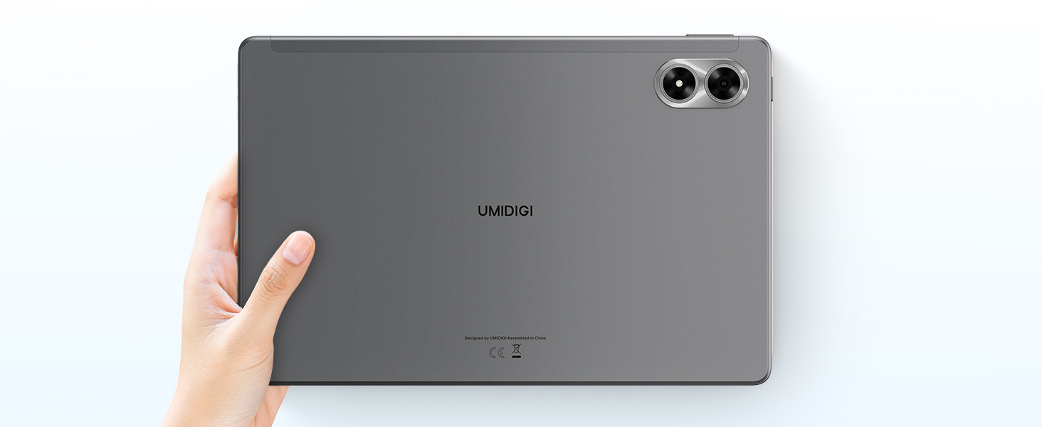 Hand holding a large, dark gray tablet device with dual rear cameras, showcasing its slim profile and back design.