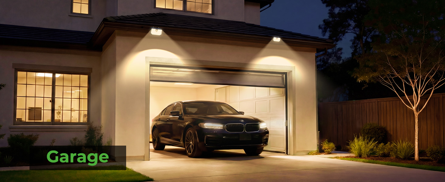 Text reads 'Garage'. Illuminated residential garage exterior at night with car visible inside and modern outdoor lighting above door.