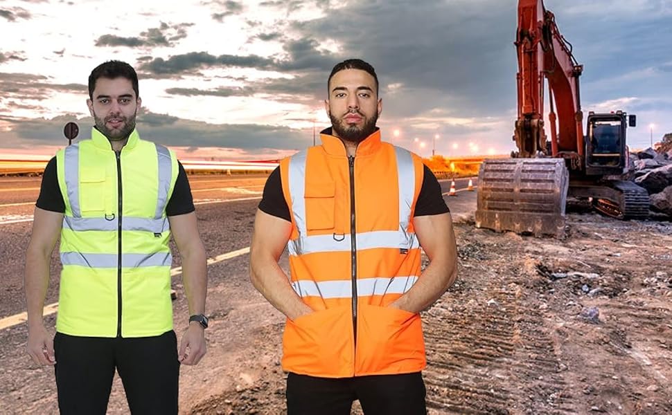 Four high-visibility safety vests in yellow and orange, worn by individuals at a construction site with machinery visible in the background.