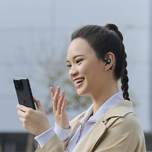 Blue wireless earbuds with curved design displayed alongside black charging case against dark blue background with subtle lighting.
