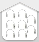 a wall of white metal hooks with a house roof in the background.