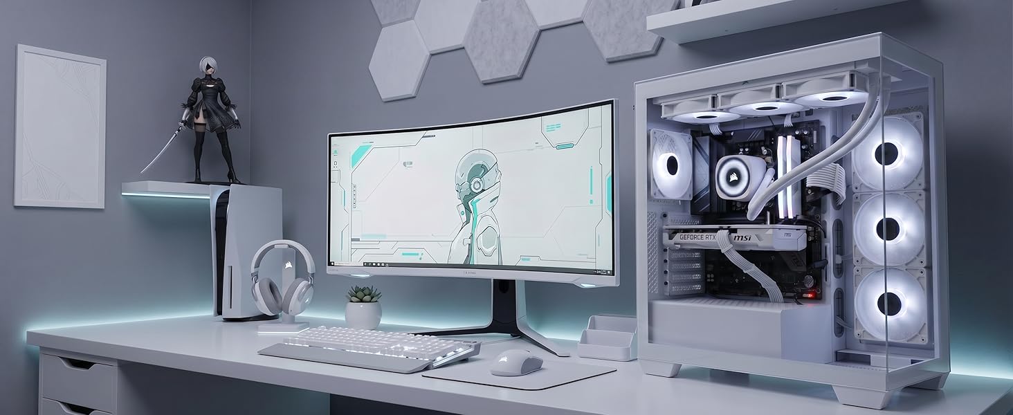 Modern gaming desk setup with dual monitors, CPU tower with RGB lighting, keyboard, mouse, and desk accessories in monochromatic aesthetic.