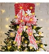 Tall artificial Christmas tree decorated with lights and star topper, surrounded by wrapped presents in red, silver, and white with bows.