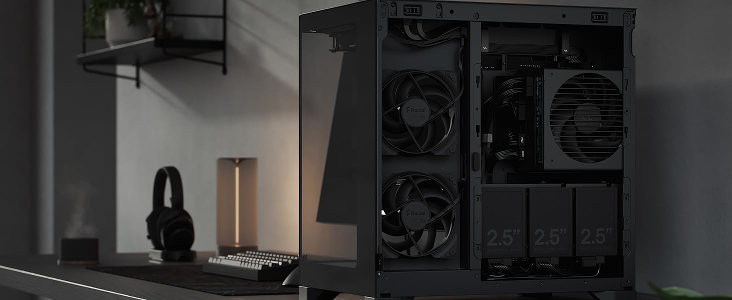 Black computer tower case on desk with internal components visible, featuring multiple cooling fans and modular layout for PC build customization.