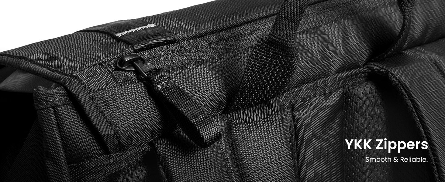 Text reads 'YKK Zippers'. Close-up of black fabric with visible zipper detail and stitching.