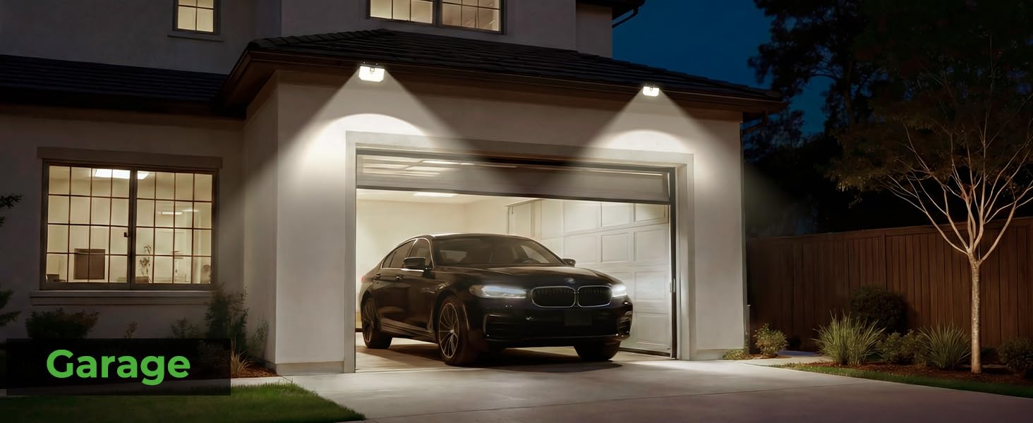Text reads 'Garage'. Night view of a modern residential property with illuminated exterior and garage area, showing contemporary architectural design.