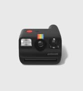 Minimalist white instant camera with rainbow stripe detail, featuring lens, viewfinder, and red shutter button against white background.