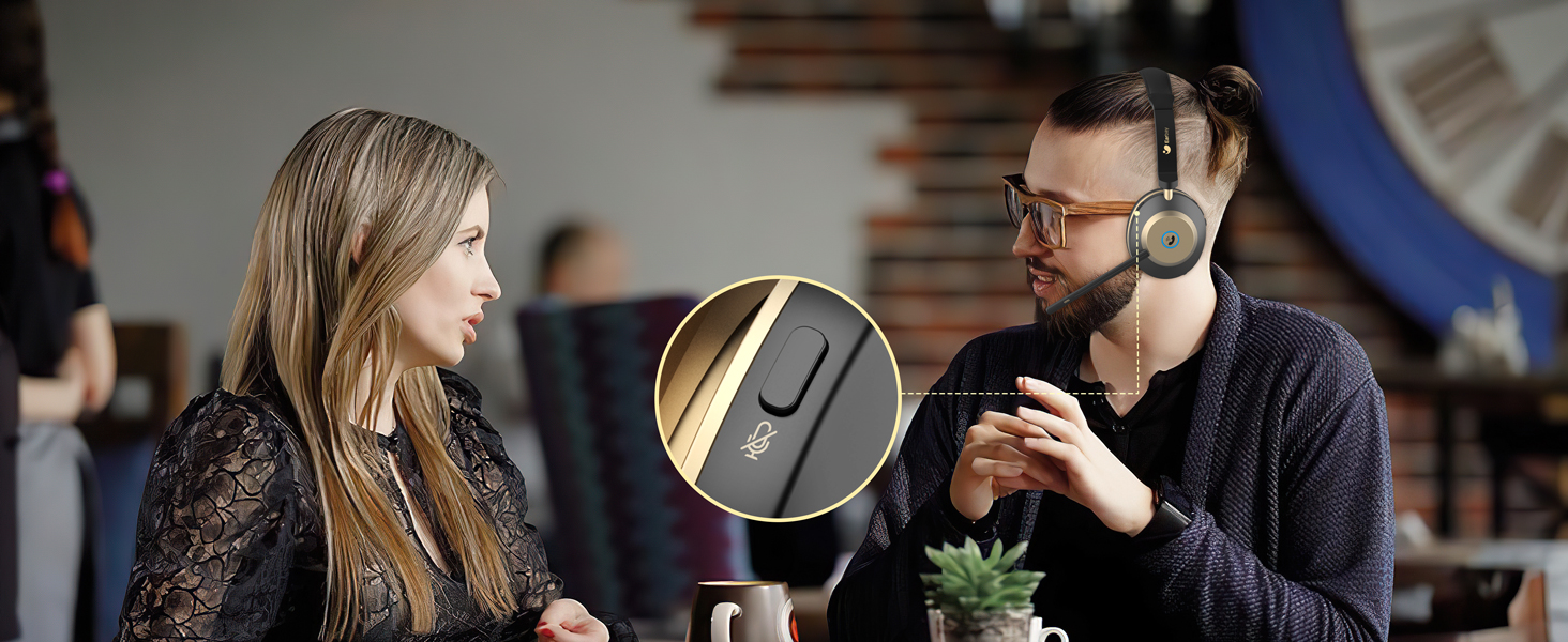 Two people conversing at a table with a circular inset image showing a black wireless earbud or headphone component with a gold accent.